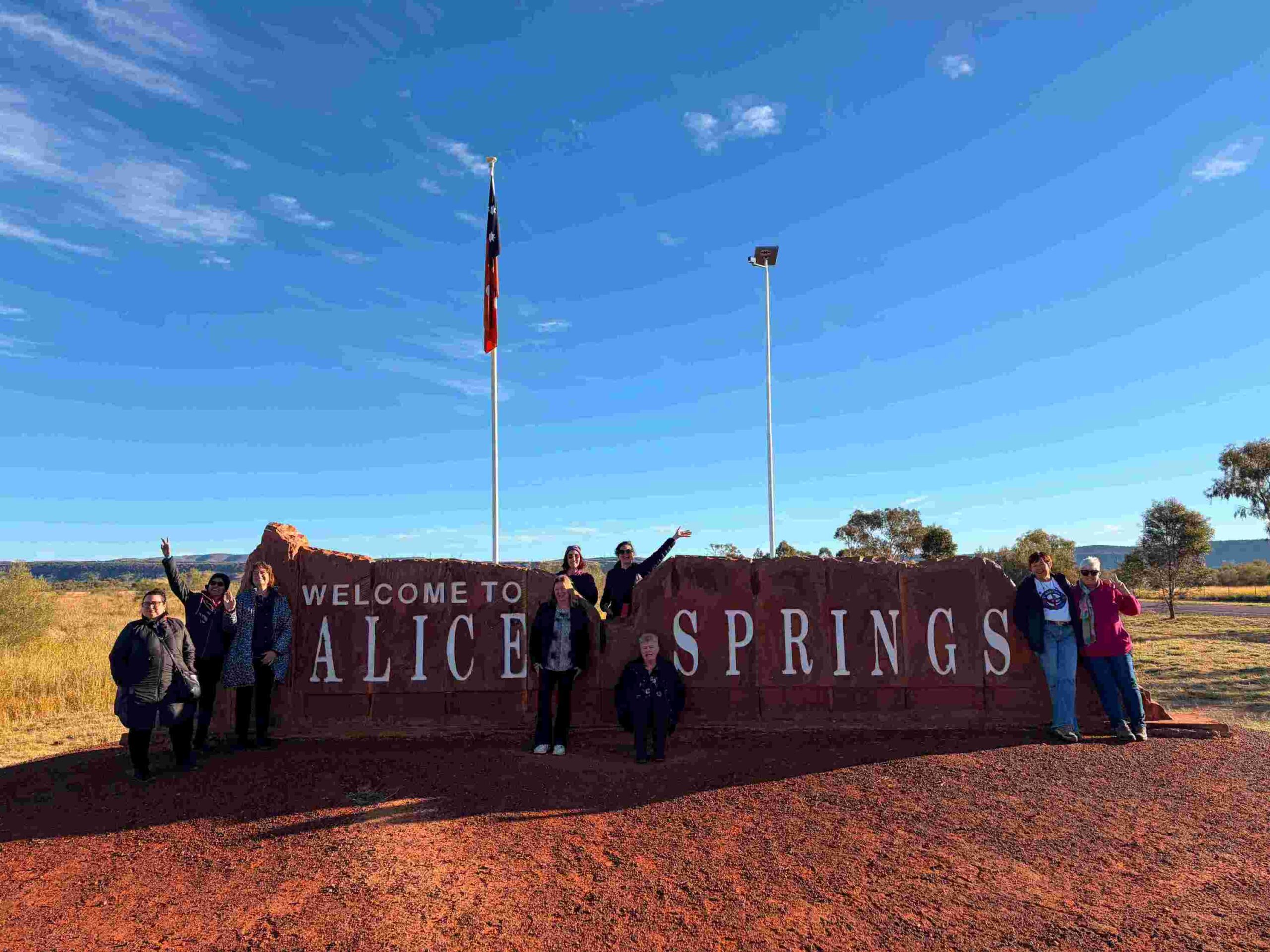 A group photo at the welcome to Alice Springs