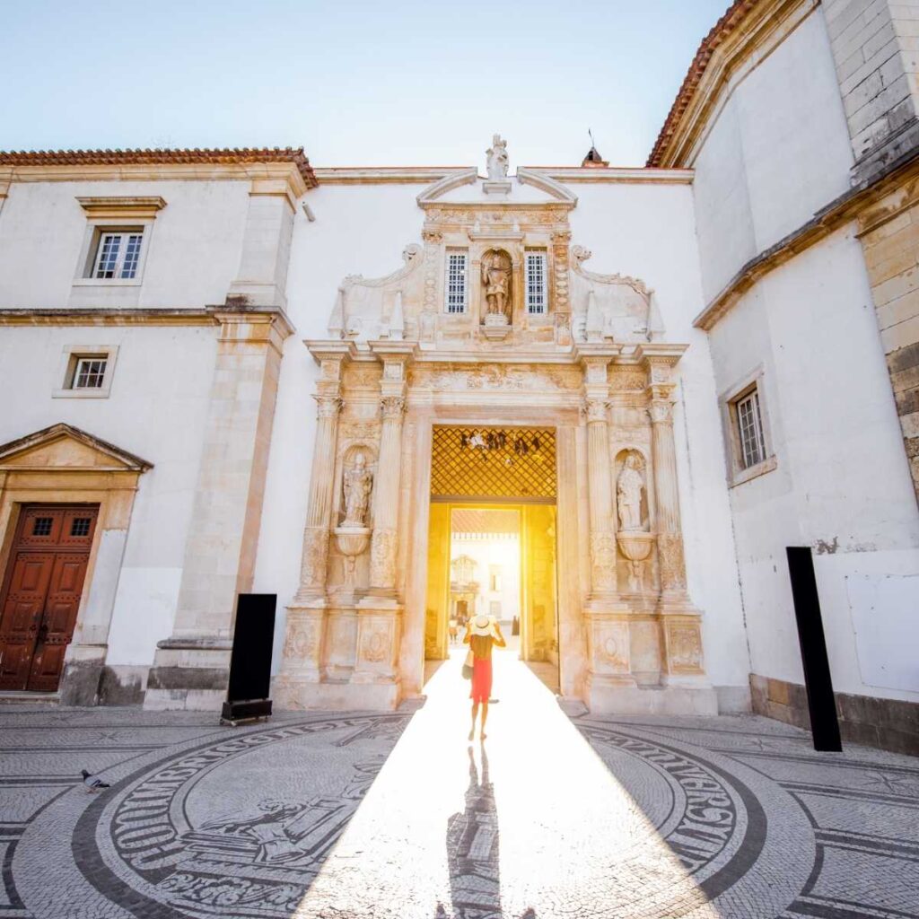 A woman stands at the entrance to the Coimbra University